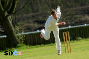 bowler doing a ball and wickets placed behind him